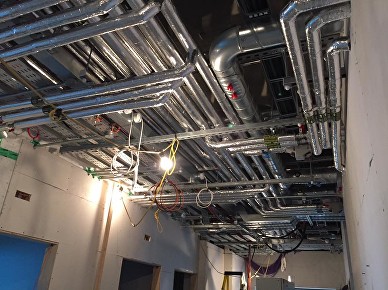 Insulated overhead pipework above building services