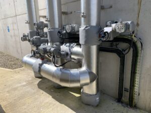 Pipework insulated with fiberglass rockwool sections and clad with aluminium in a waste water treatment facility in Cork