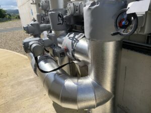 Pipework insulated with fiberglass rockwool sections and clad with aluminium in a waste water treatment facility in Cork