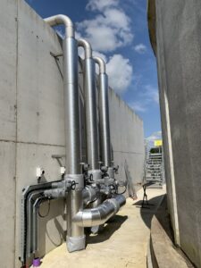 Pipework insulated with fiberglass rockwool sections and clad with aluminium in a waste water treatment facility in Cork