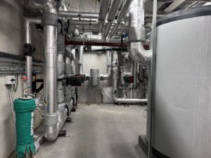Insulation and protective aluminium cladding fitted to heating pipework in new energy center in Ireland
