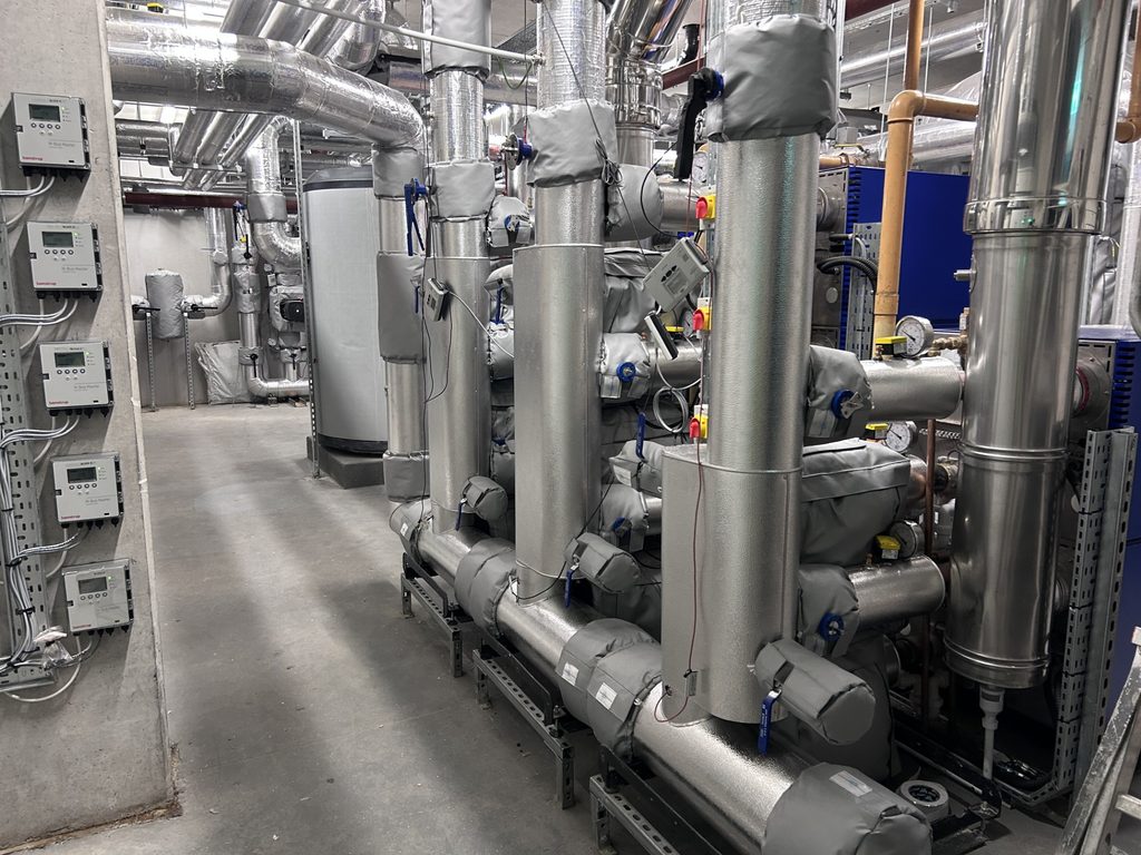 Insulated plant room pipework with removable valve jackets and metal cladding