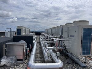 External insulated pipework beside roof plant