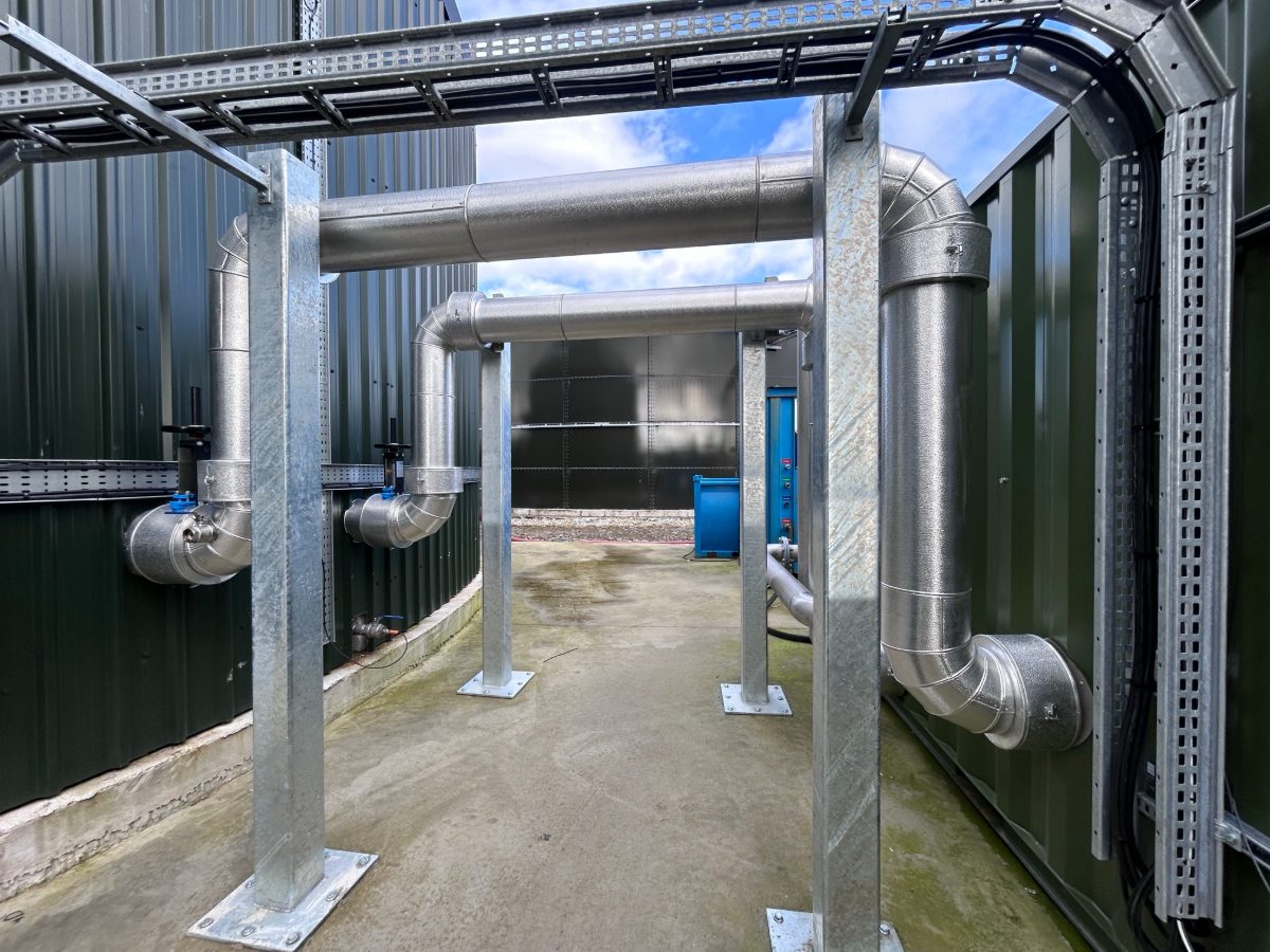 Insulated pipework with aluminium cladding on supports at a biogas energy plant in Ireland