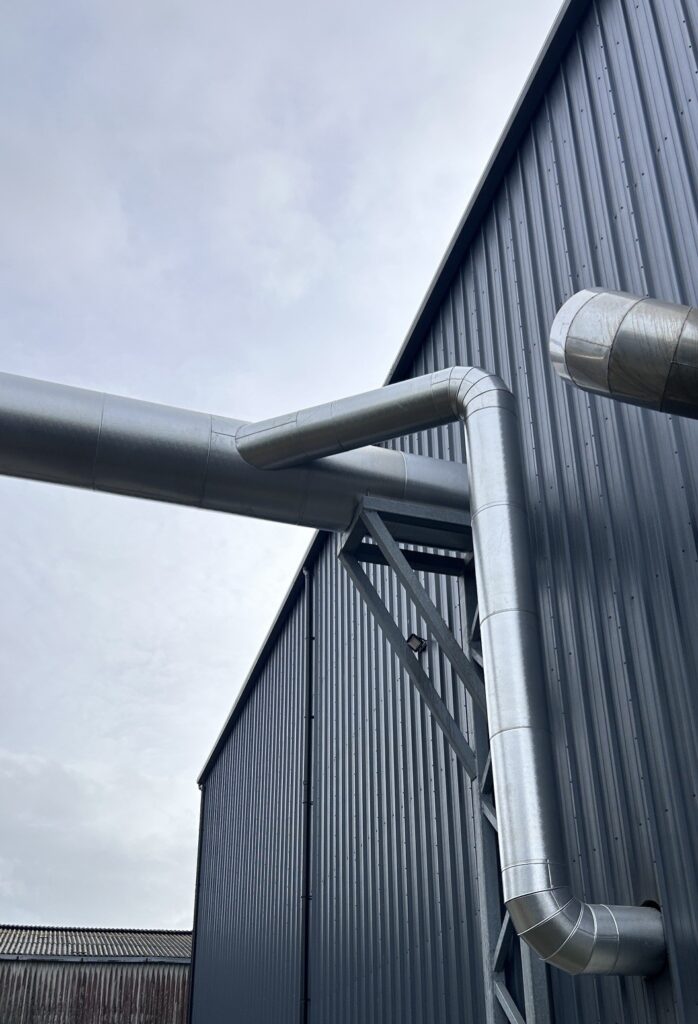 Formed aluminium cladding on flue bends where the flue drops down the building, Co. Meath