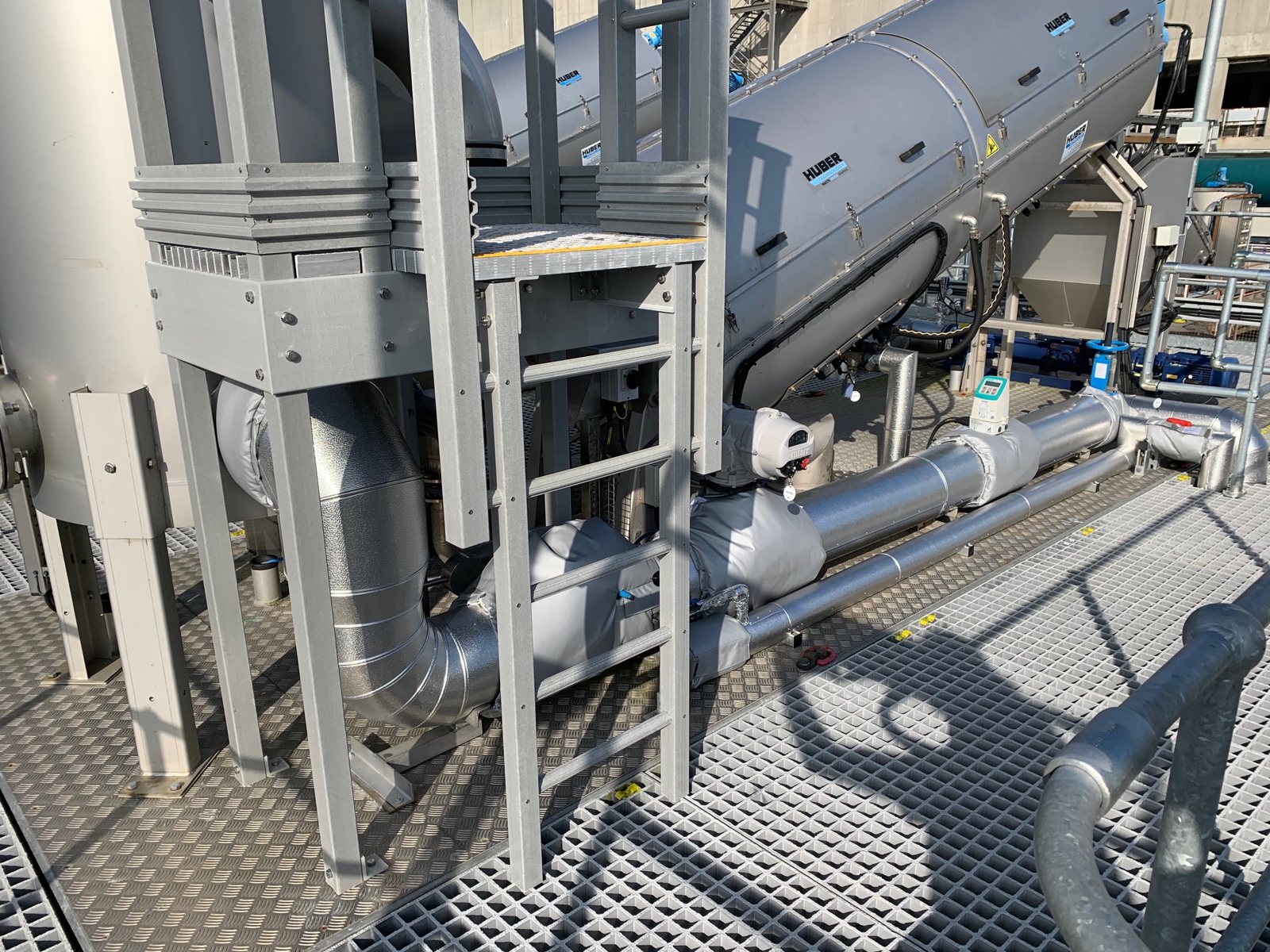 Insulated and metal-clad pipework on waste water plant equipment.