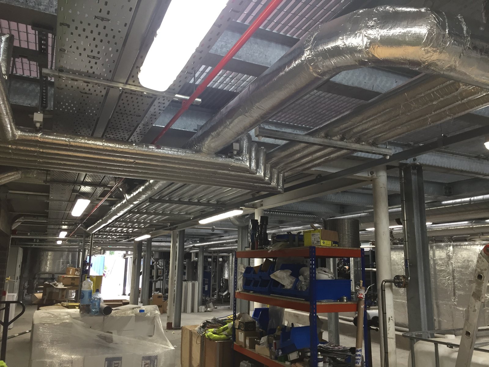 Insulated pipe runs and ventilation services within a distillery.