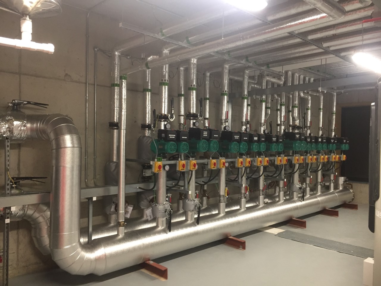 Insulated boiler-house heating header and circulation pumps