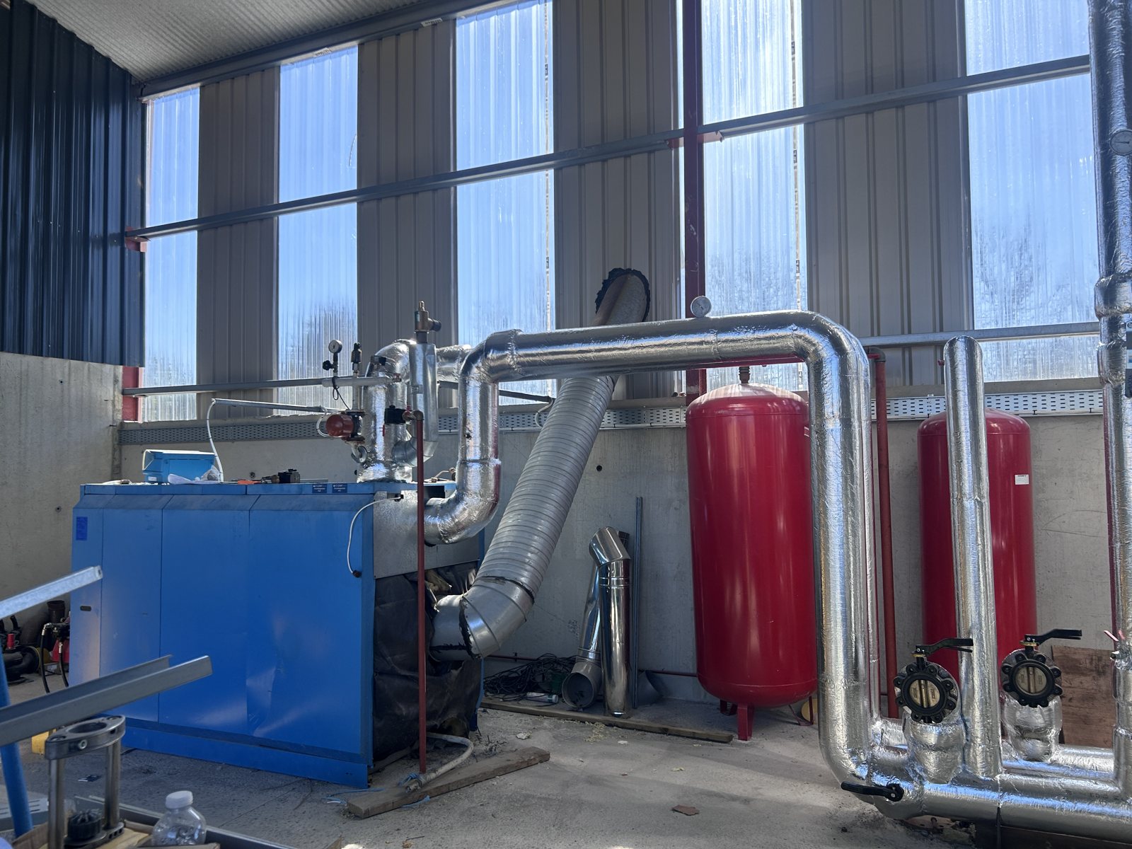 Insulated pipework connecting plant-room equipment and headers.