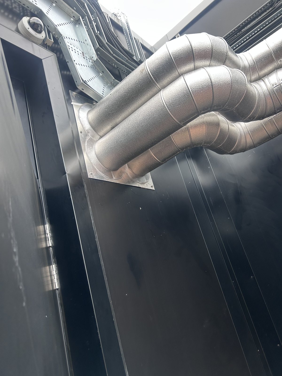 Formed cladding around pipe bends and a wall penetration.